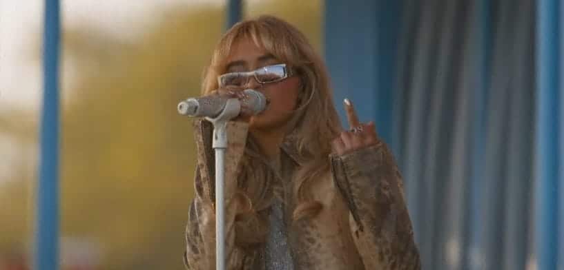 Sabrina Carpenter flashes a middle finger to the camera as she performs for the first time at Coachella.