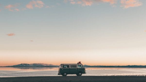 A minivan in front of a Utah sunset and the Bonneville Salt Flats.