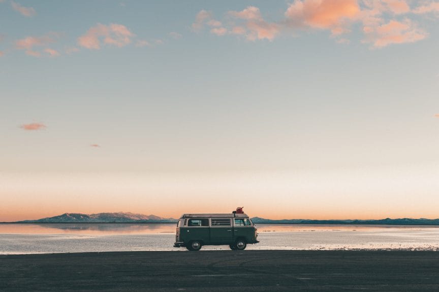 A minivan in front of a Utah sunset and the Bonneville Salt Flats.