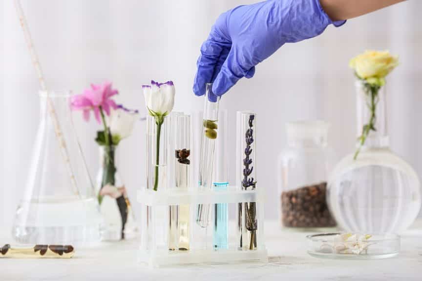 Woman preparing perfume on table.