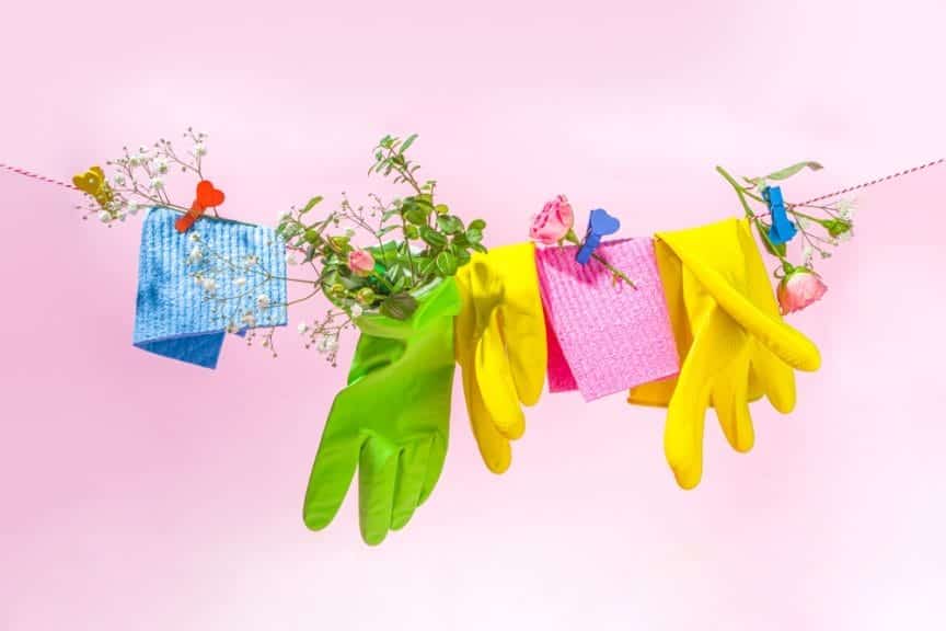 Vibrant colored string of gloves and cloths used for cleaning.