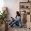 Girl home surrounded by boxes