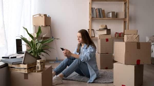 Girl home surrounded by boxes