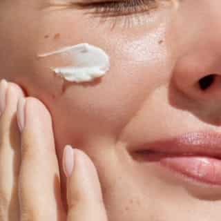 Woman's face with moisturizer.