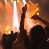 Crowd at festival with hands in air