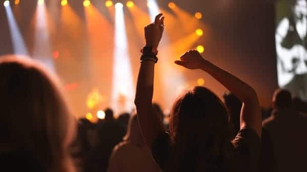 Crowd at festival with hands in air