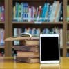 Pile of books with a tablet propped against it