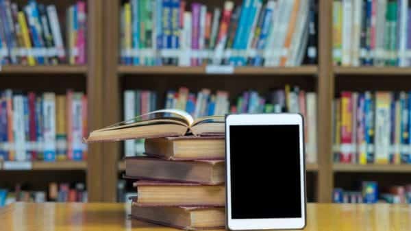 Pile of books with a tablet propped against it