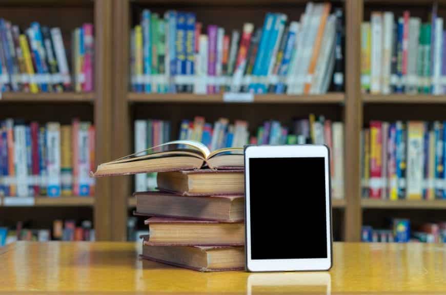 Pile of books with a tablet propped against it