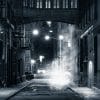 A black and white photo of an almost empty street in New York City.