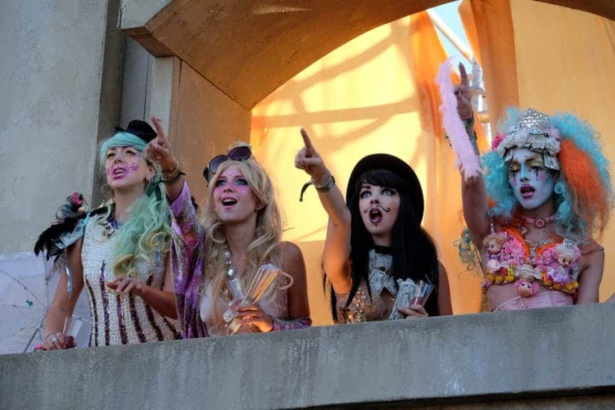 People dressed up at Boomtown festival pointing at the sky