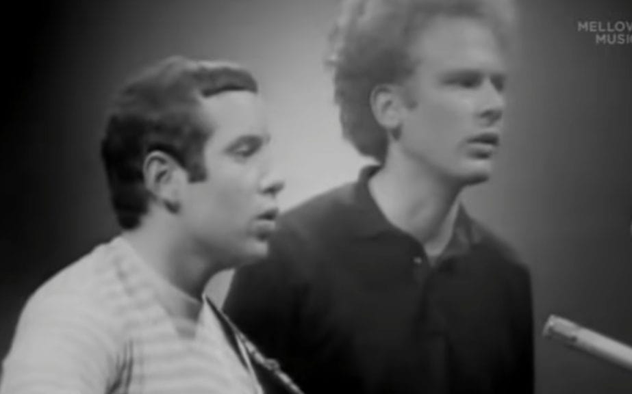 Simon & Garfunkel seen performing in profile in 1965.