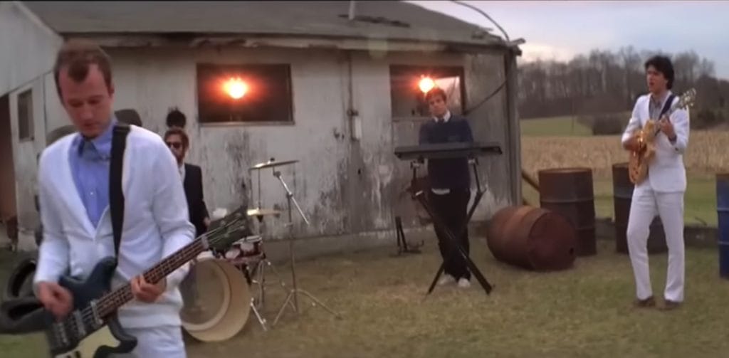 Vampire Weekend performing outside of an old house in the music video for their song "Oxford Comma". 