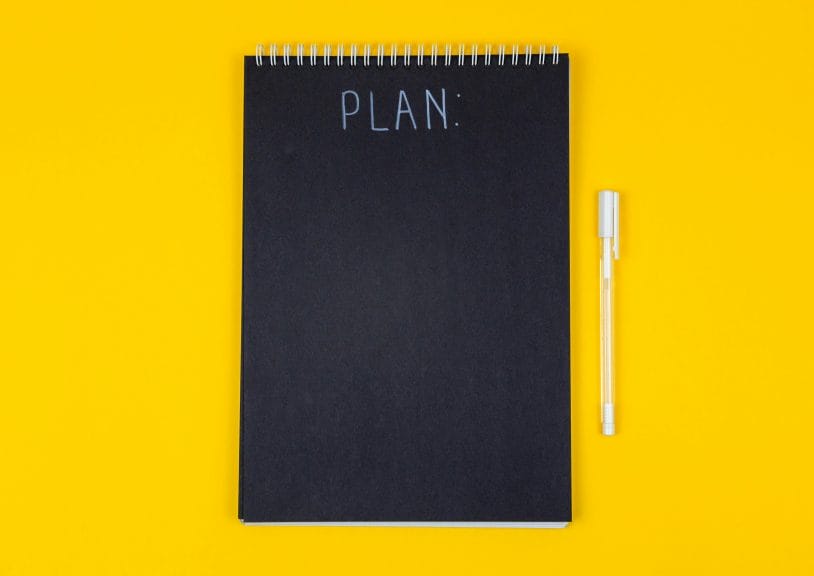 notebook with the word "plan" 