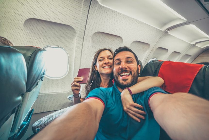 Young couple on airplane during summer travel trip