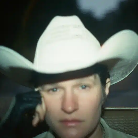 Close up out of focus portrait of Adrianne Lenker in a cowboy hat