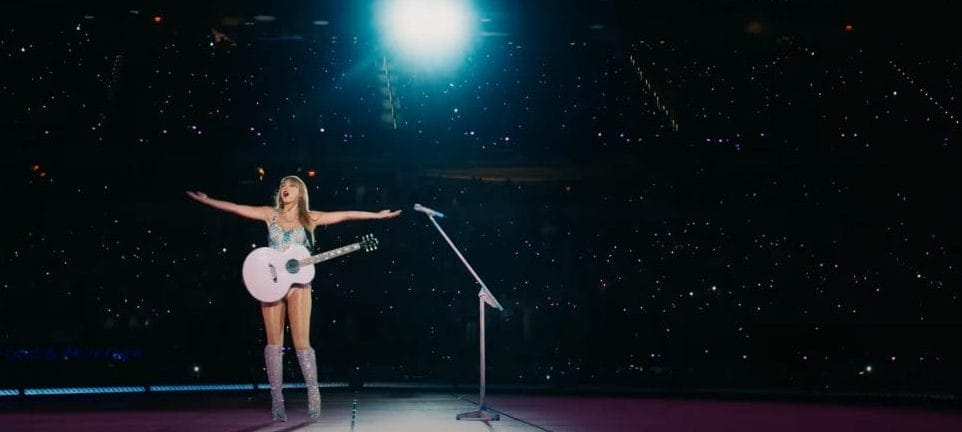 Taylor Swift performing to a crowd on tour