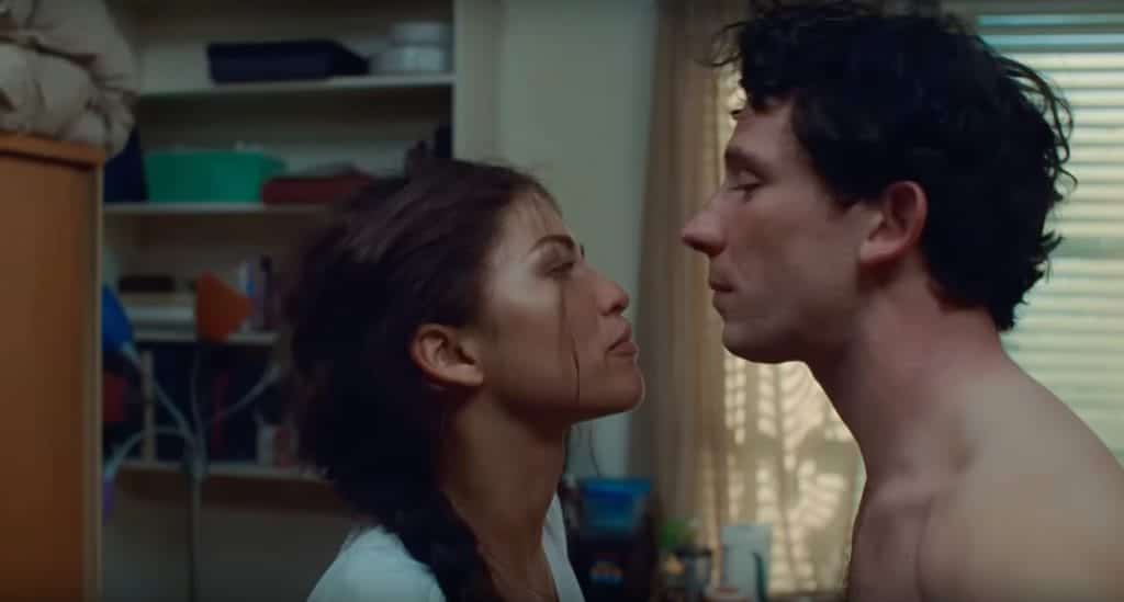 A man and woman stare at each other, angry.