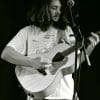 Jay from Crywank playing the guitar in a black and white image