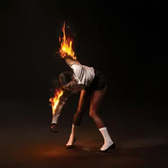 St. Vincent frantically putting her arms out of fire