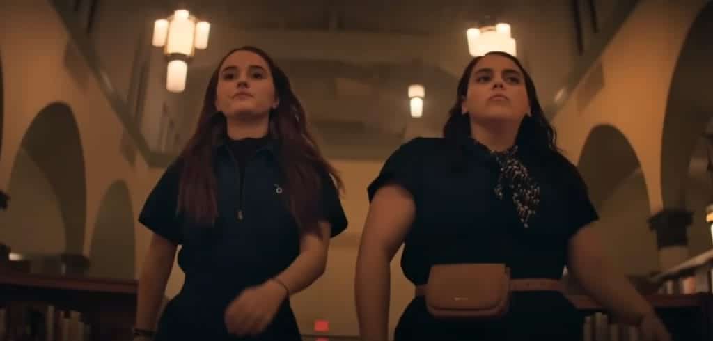 The two main characters of Booksmart walk in slow motion in their matching outfits with confident looks on their faces.