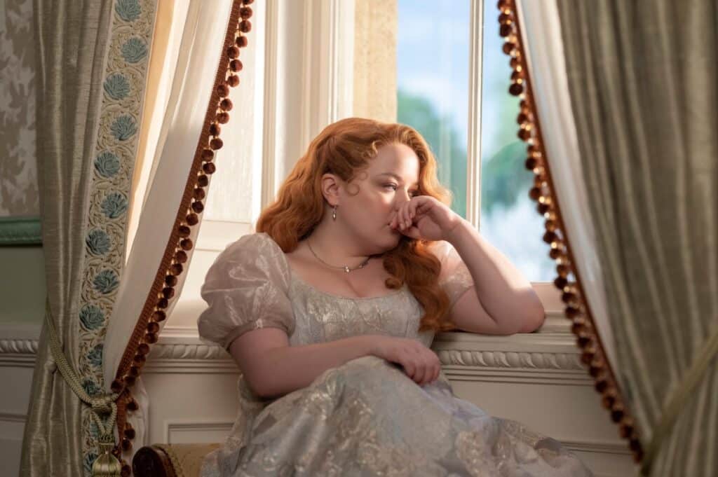 Penelope Featherington as she stares out the window in deep thought.