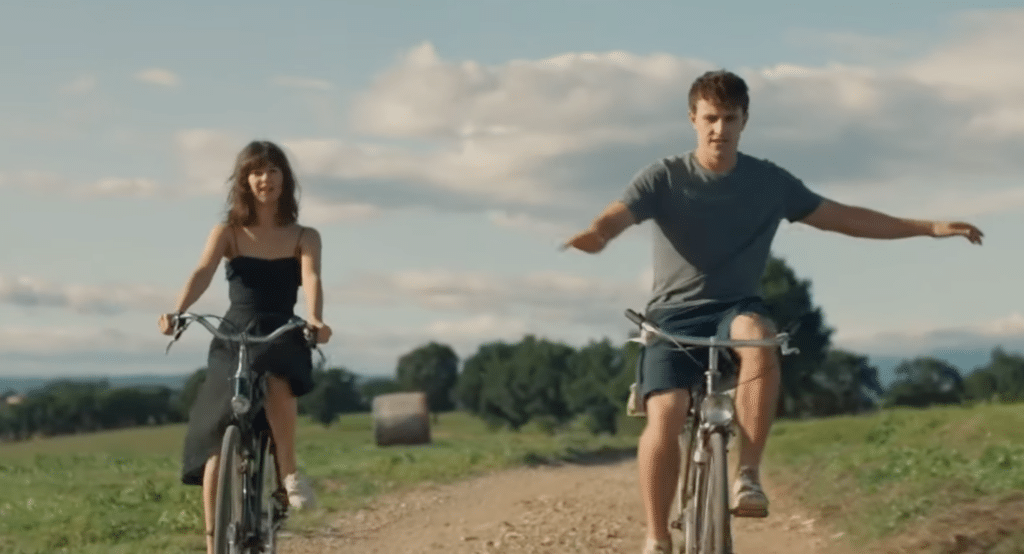 The two main characters of the show "Normal People" ride bikes through the Italian countryside.