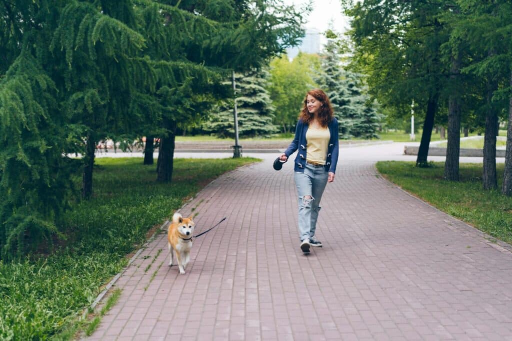 Girl walking dog to demonstrate maturity.