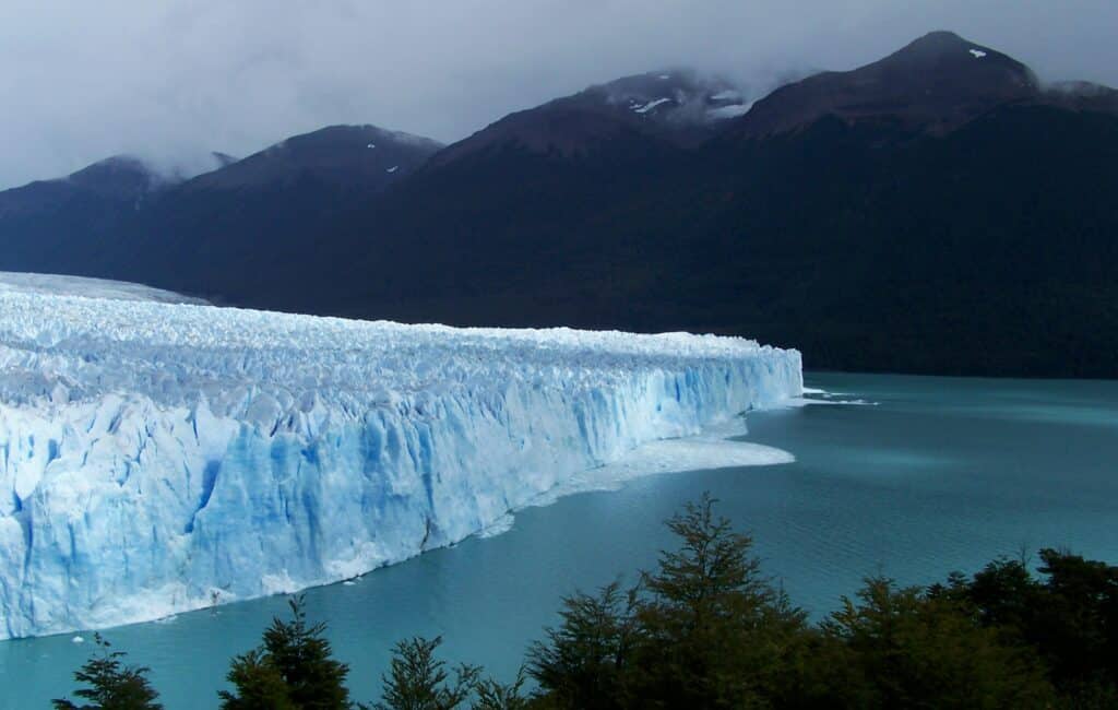 a glacier with mountains behind it