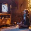 Child watching TV on a retro box TV.