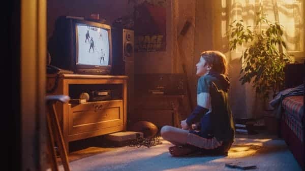 Child watching TV on a retro box TV.