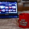 Laptop screening Netflix with mug stating "just one more episode"