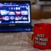 Laptop screening Netflix with mug stating "just one more episode"