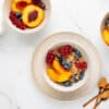 top down view of bowls with oatmeal and fruit on a clean surface
