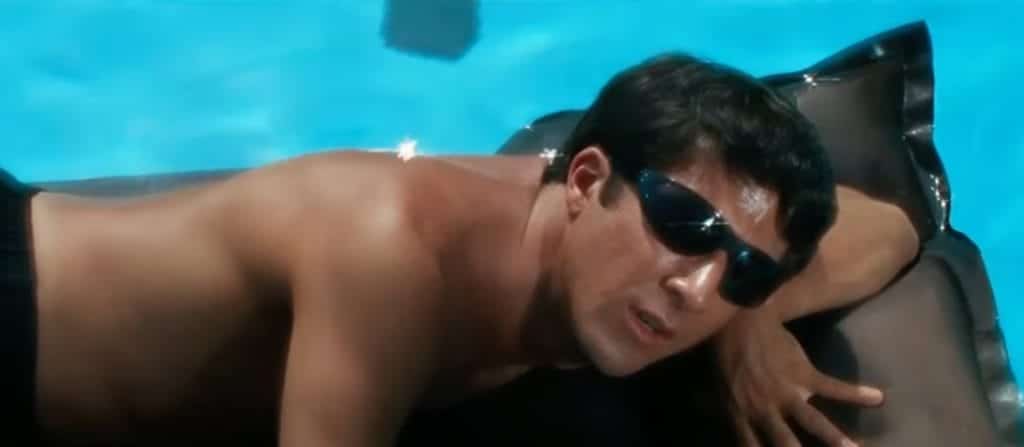 Dustin Hoffman as Ben, in The Graduate, lounges on a floatie in the pool wearing sunglasses.