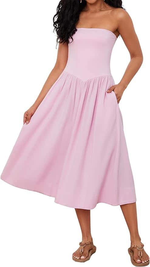 Model wearing a baby pink flowy mid-length dress.