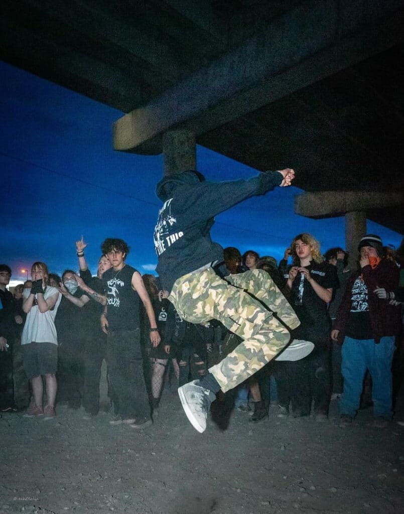 A fan in the middle of a jump for the crowd during a show.