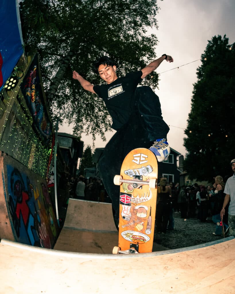 A wide-angle capture of a skater at a punk show.