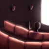 Lone person seated at the movie theater.