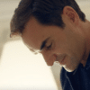Roger Federer reading his retirement announcement. A man looking down, in a room which is brightly lit.