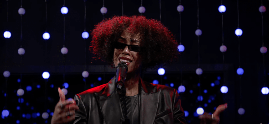 Rochelle Jordan singing on stage with a passionate facial expression.