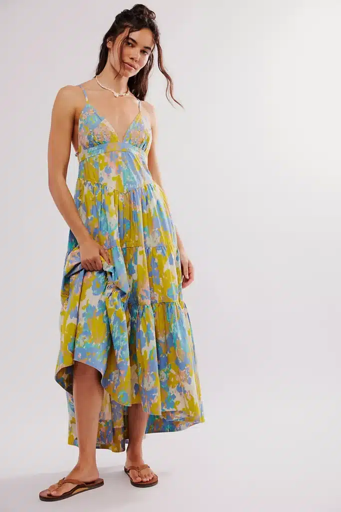 Model wearing a multicolored long flowy sundress.
