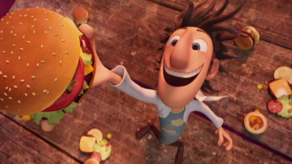 Flint Lockwood grinning at the sky as he holds one of his burgers.