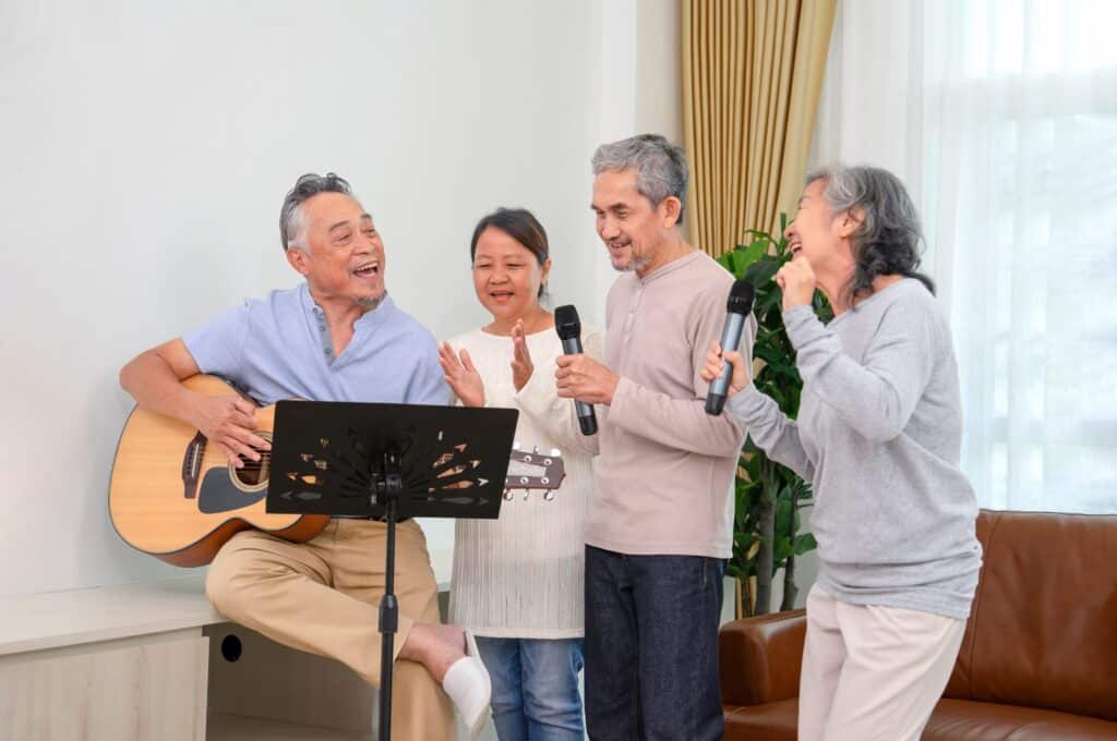 Group of friends singing along to guitar