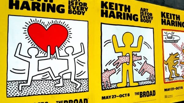 Advertisements for the Keith Haring: Art is for Everybody show at The Broad are plastered on a wall.