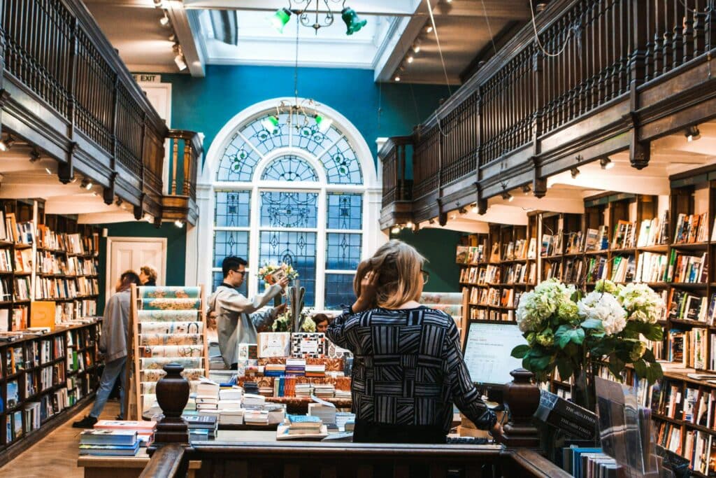 A photo of a woman at the register in an independent bookstore