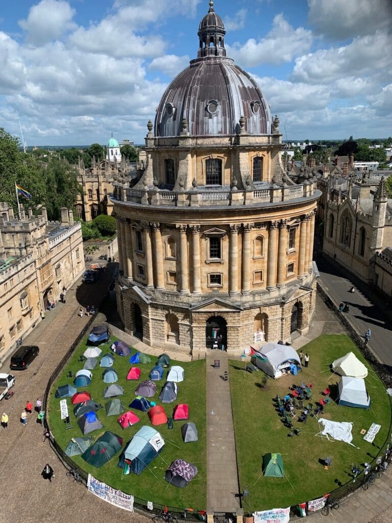 Tents and flags surround the Radcliffe Camera (Oxford University library).