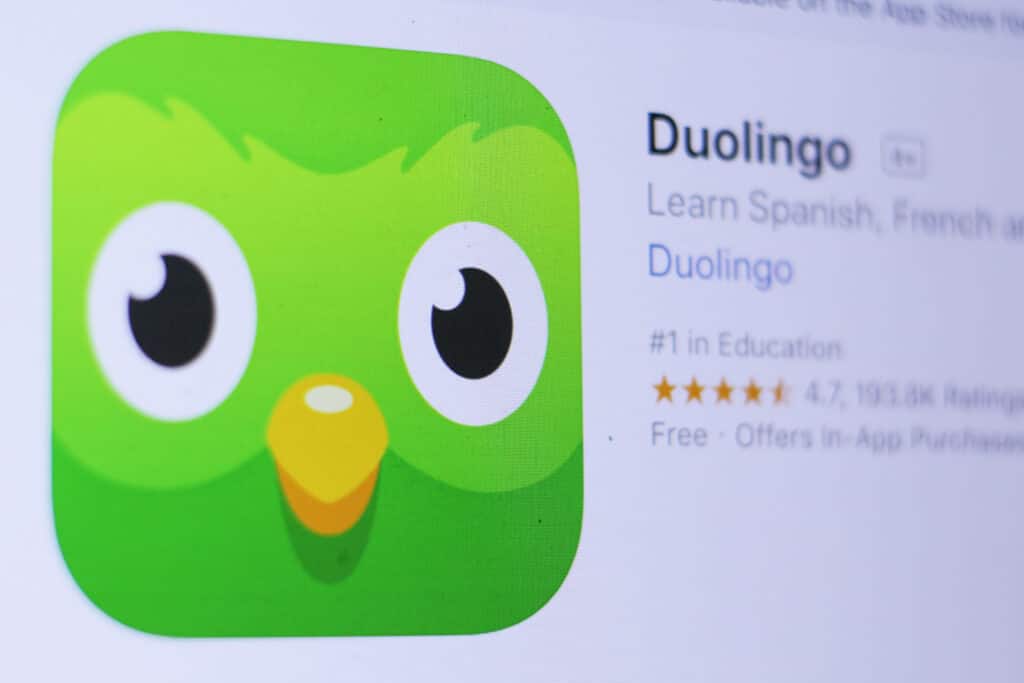 The Duolingo logo is shown in the app store with its ranking of being the #1 app in Education, alongside a handful of the languages that can be learnt after download, such as Spanish and French.