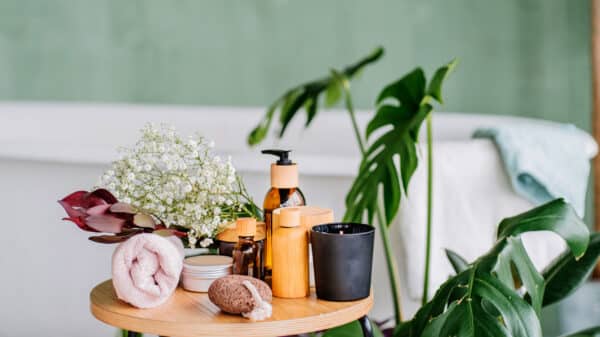 Photo of eco spa toiletries on a table sitting in front a bath.