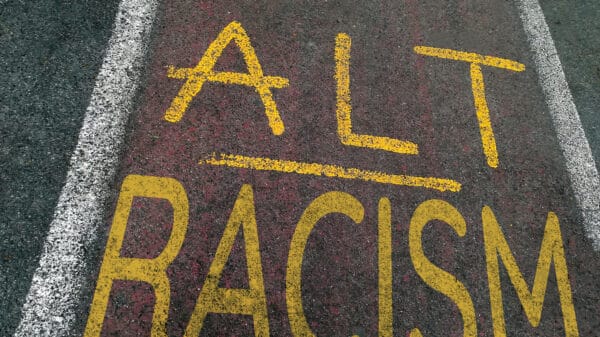 Chalk written on pavement in opposition to racist Nazi and alt-right ideology of Agartha and Hyperborea